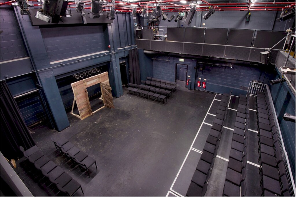 View of the Ron Barber Studio from above. The stage is bare and the seating is in thrust layout, with seating on three sides of the acting area.